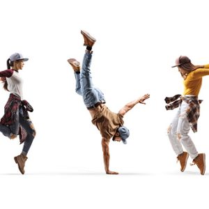 Two female dancers and one male dancer performing a hand stand isolated on white background